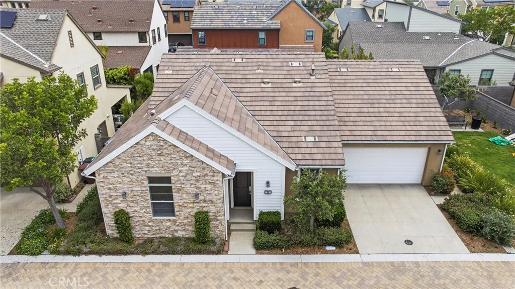 Beautiful front exterior with stone accents, modern farmhouse-inspired architecture, attached two-car garage, and professionally landscaped curb appeal.