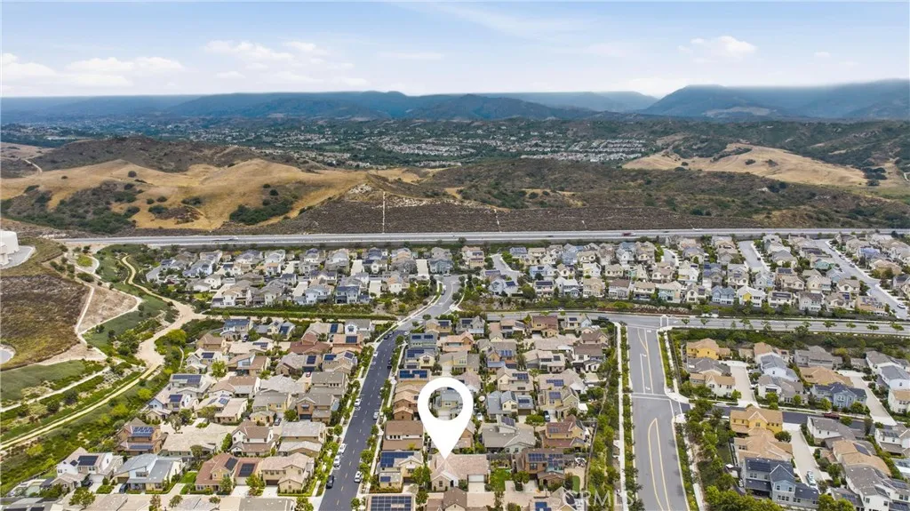Aerial view showcasing the home’s prime location within a thoughtfully planned community surrounded by scenic rolling hills and open space.