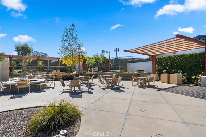Community gathering space with fire pit seating and beautifully landscaped surroundings.