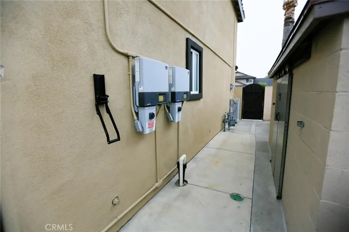 West side of house with Storage with Elevator Doors made of Block. Solar Boxes and Tesla Back-up Batteries