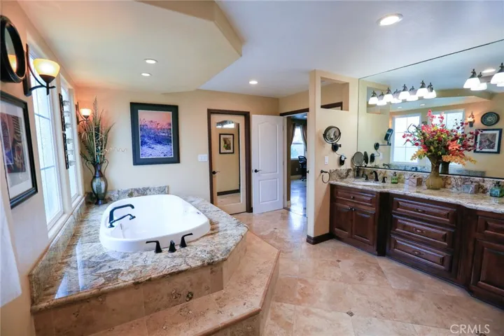 His and Hers sinks, Mirrored door to walk-in closet with Aeromantic Tub for two