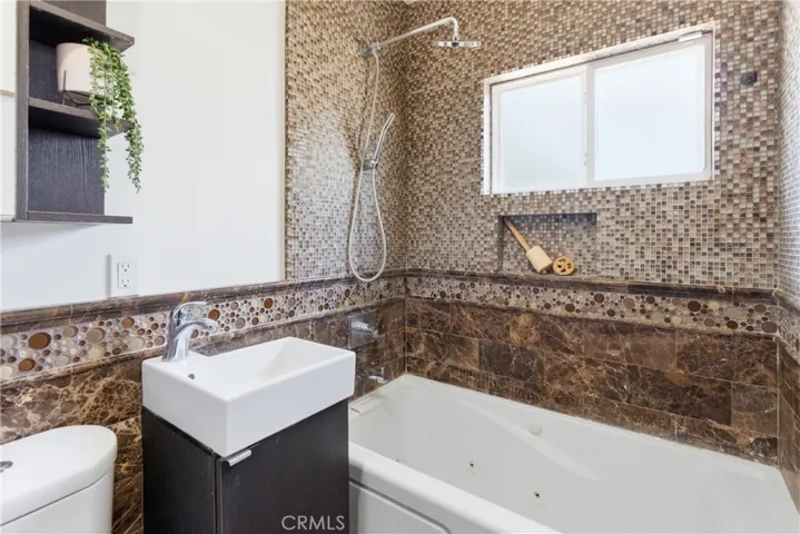 Hallway bathroom with jetted tub and shower