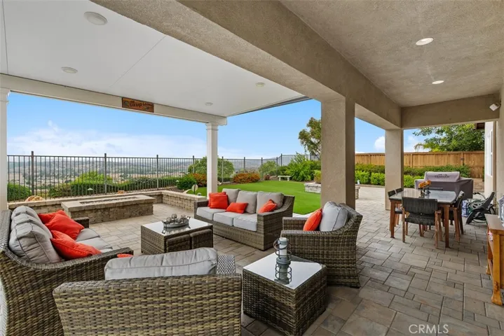 Custom paved hardscape complete with fire pit, outdoor seating, builtin Loggia and extended Alumawood patio perfect for the Temecula Outdoor Lifestyle!