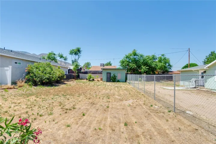This lot is also included with the house on the other side of the chain link fence.
