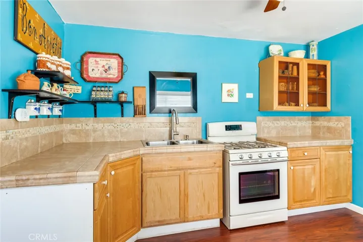 A bright and cheerful kitchen with upgraded countertops and custom glass front cabinets.