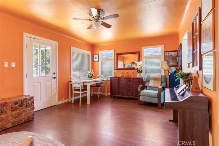 Beautiful flooring, an elegant door, framed windows, and custom paint add to the doll house charm of the living and dining room.
