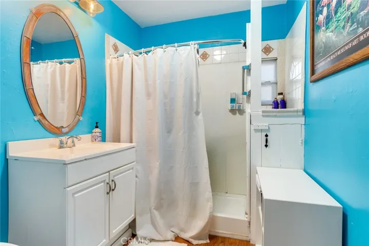 The bathroom features a remodeled vanity and a step in shower.