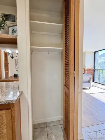 Kitchen features a coat/utility closet