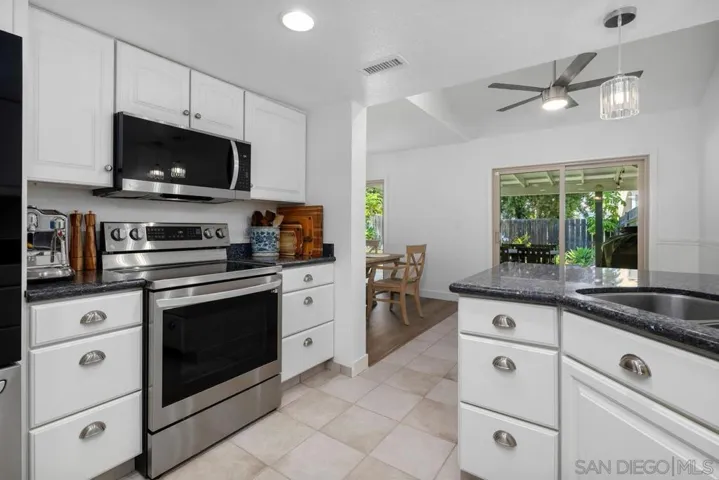 Updated kitchen with great flow. Granite countertops, white cabinetry and upscale LG appliances. Pantry features pull-out drawers.