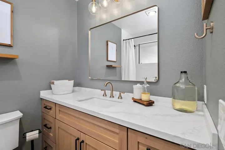 Guest bedroom en suite has been remodeled featuring new vanity, shower/tub combo with white subway tile, Kohler fixtures.