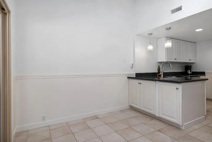 Informal space off the kitchen with access to the backyard would make a great breakfast room, office, or play space.