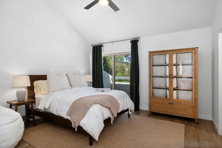 Guest bedroom with completely remodeled ensuite, vaulted veiling, access to private balcony overlooking the backyard.