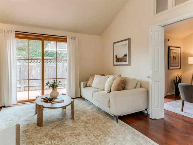 Living room has double doors that access the guest room/office space