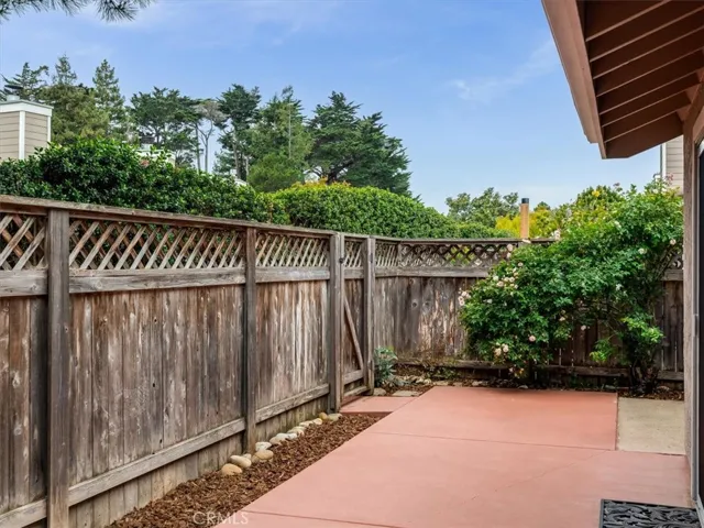 Gate from patio leads to pathways running throughout the beautifully maintained community grounds and swimming pool.