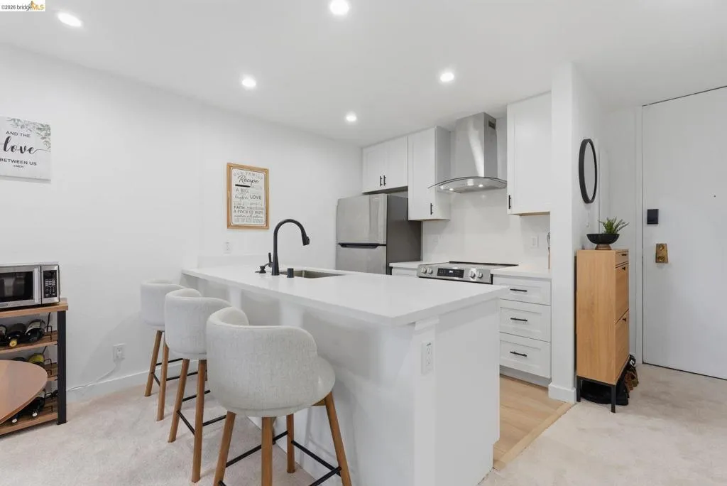 Modern kitchen featuring an island with a built-in sink and seating