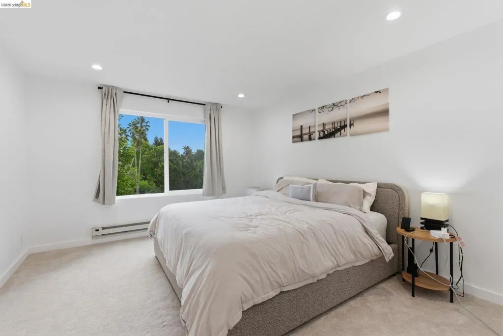 Neutral white walls and light-toned carpeting create a bright interior