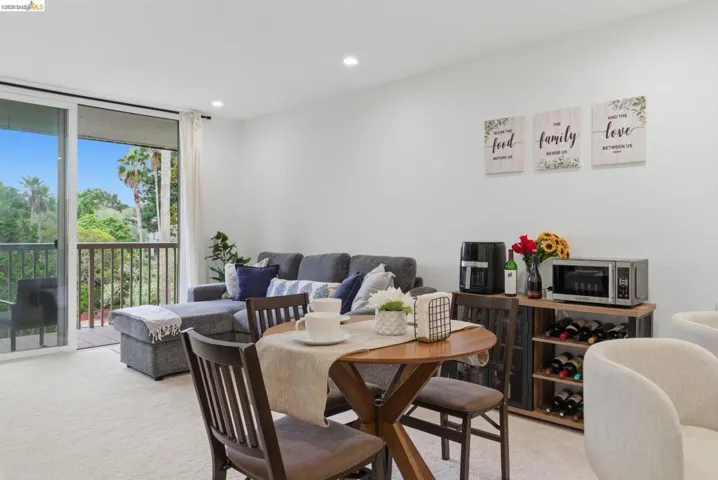 Living area with sliding glass doors opening to a private balcony