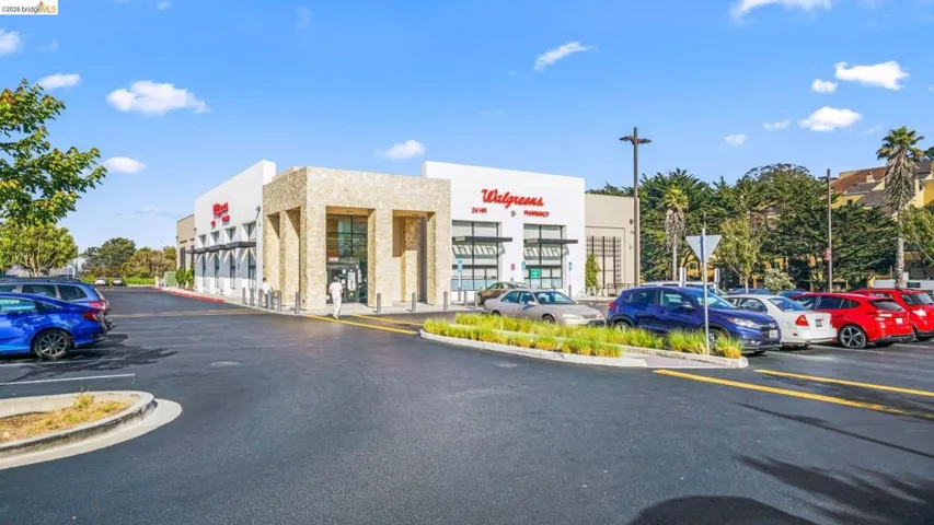 Modern commercial building with a stone-clad facade and prominent storefront windows