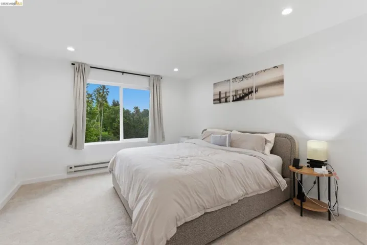 Neutral white walls and light-toned carpeting create a bright interior