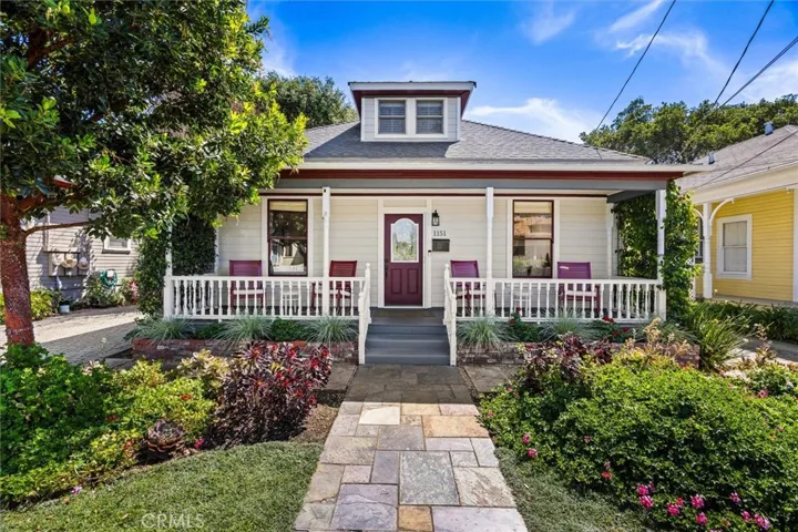 Charming entry with covered porch and low maintenance landsacping.