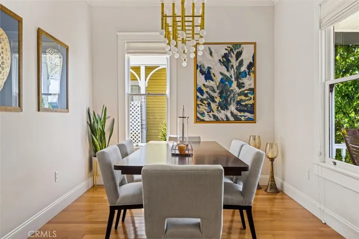 Dining room with great natural light, timeless hardwood floors, and detailed moulding.