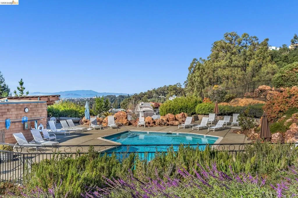 Community pool with perimeter fencing and a concrete deck