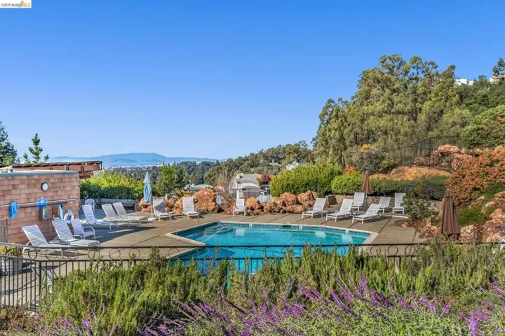 Community pool with perimeter fencing and a concrete deck