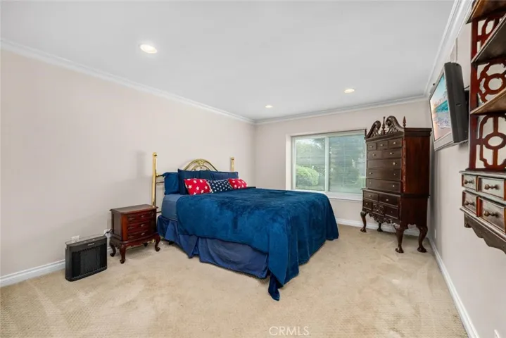 High ceilings and large window in primary suite.