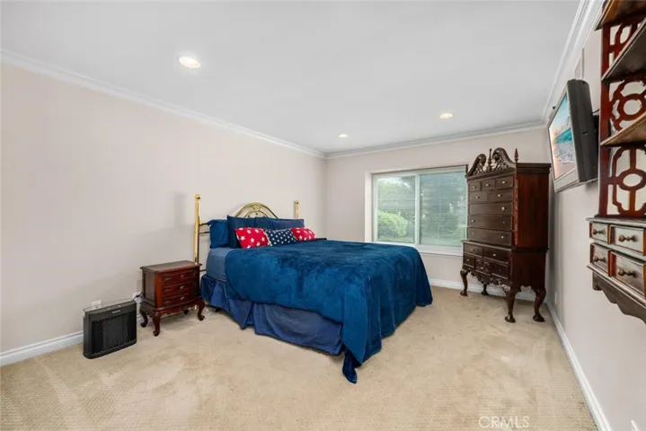High ceilings and large window in primary suite.