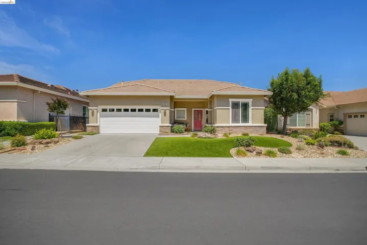 Single-story residence featuring a two-car garage with a paneled door