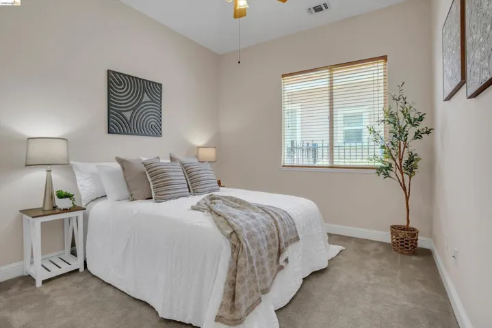 Neutral-toned walls complement the gray carpeting