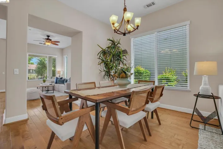Light wood-finish flooring extending from the dining area to the living space
