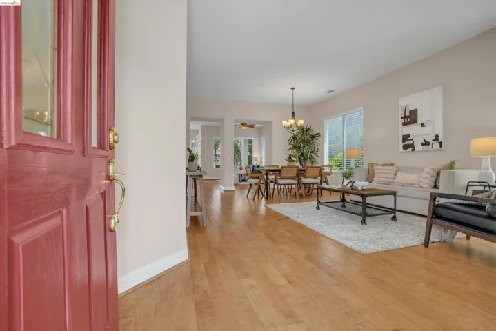 Entryway featuring a red paneled door with glass inserts and brass hardware