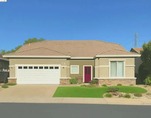 Stucco exterior with a tiled roof and a two-car garage