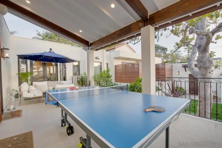 Backyard patio with table tennis and built-in BBQ.