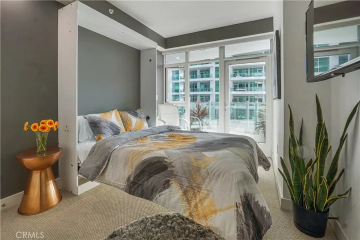 Secondary bedroom with Murphy bed opened and access to balcony