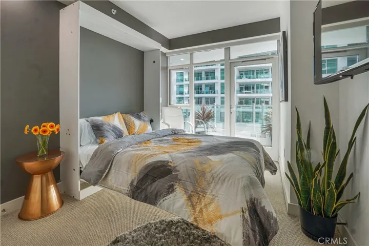 Secondary bedroom with Murphy bed opened and access to balcony