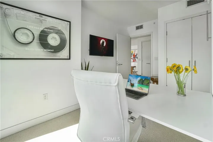Secondary bedroom with Murphy bed closed and desked opened