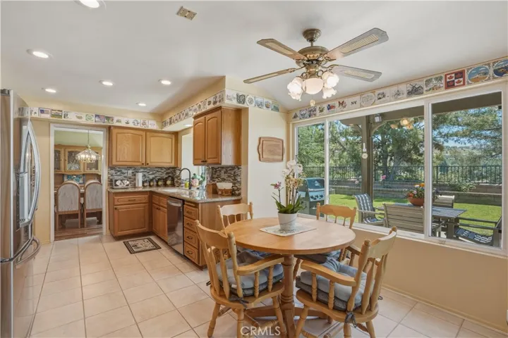 Eating area with ceiling fan and views of the backyard