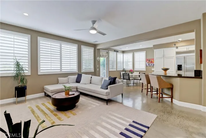 Den is open to the additional dining area and the kitchen.
