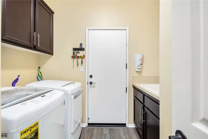 Inside laundry room w/sink and cabinets.