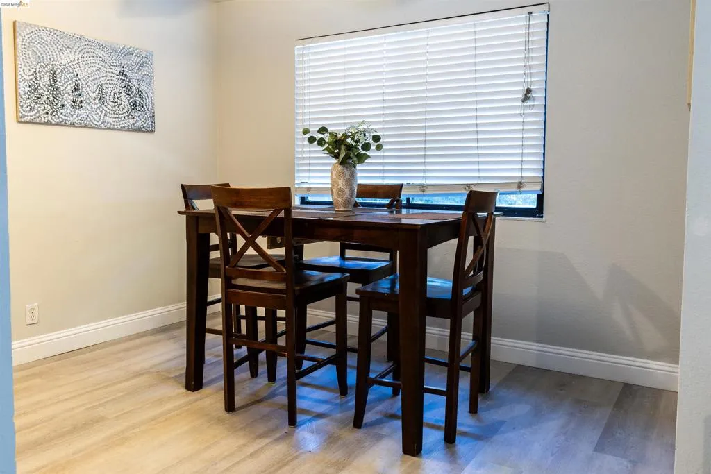 Neutral wall tones with light wood-finish flooring and white baseboards