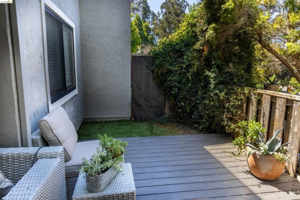Outdoor deck space with composite decking and a wooden railing