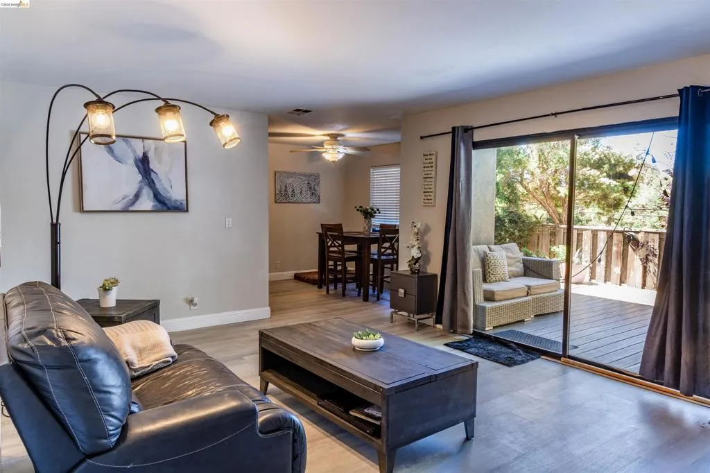 Interior living space featuring wood-finish flooring, light gray wall tones, and recessed lighting