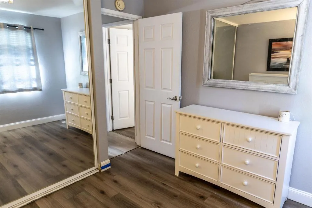 Wood-finish flooring throughout, paired with light gray wall tones