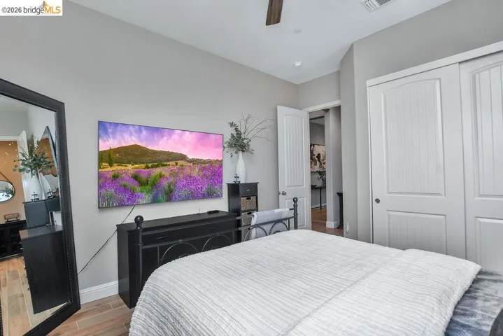 Recessed lighting illuminates wood-finish flooring