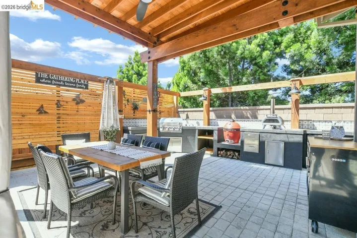 Outdoor living area featuring a wood pergola and patio pavers