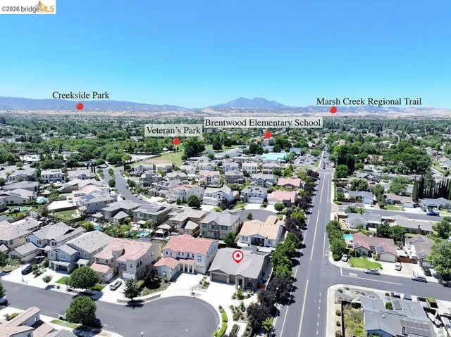 Aerial perspective of a residential neighborhood with distant mountains