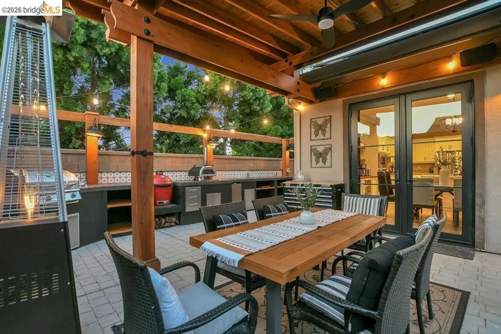 Covered outdoor patio featuring a wood pergola and paver stone flooring