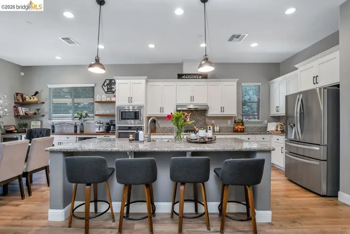 Central kitchen island with a light-toned countertop and pendant lighting